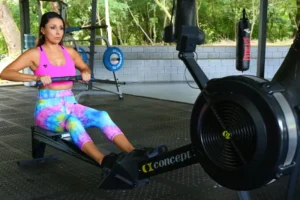 ladt on an indoor rowing machine at Atlantis Gym in Tiptree, Essex