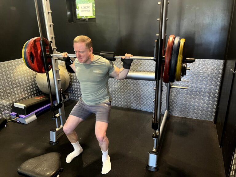 member squatting on the smith machine at atlantis gym in tiptree essex